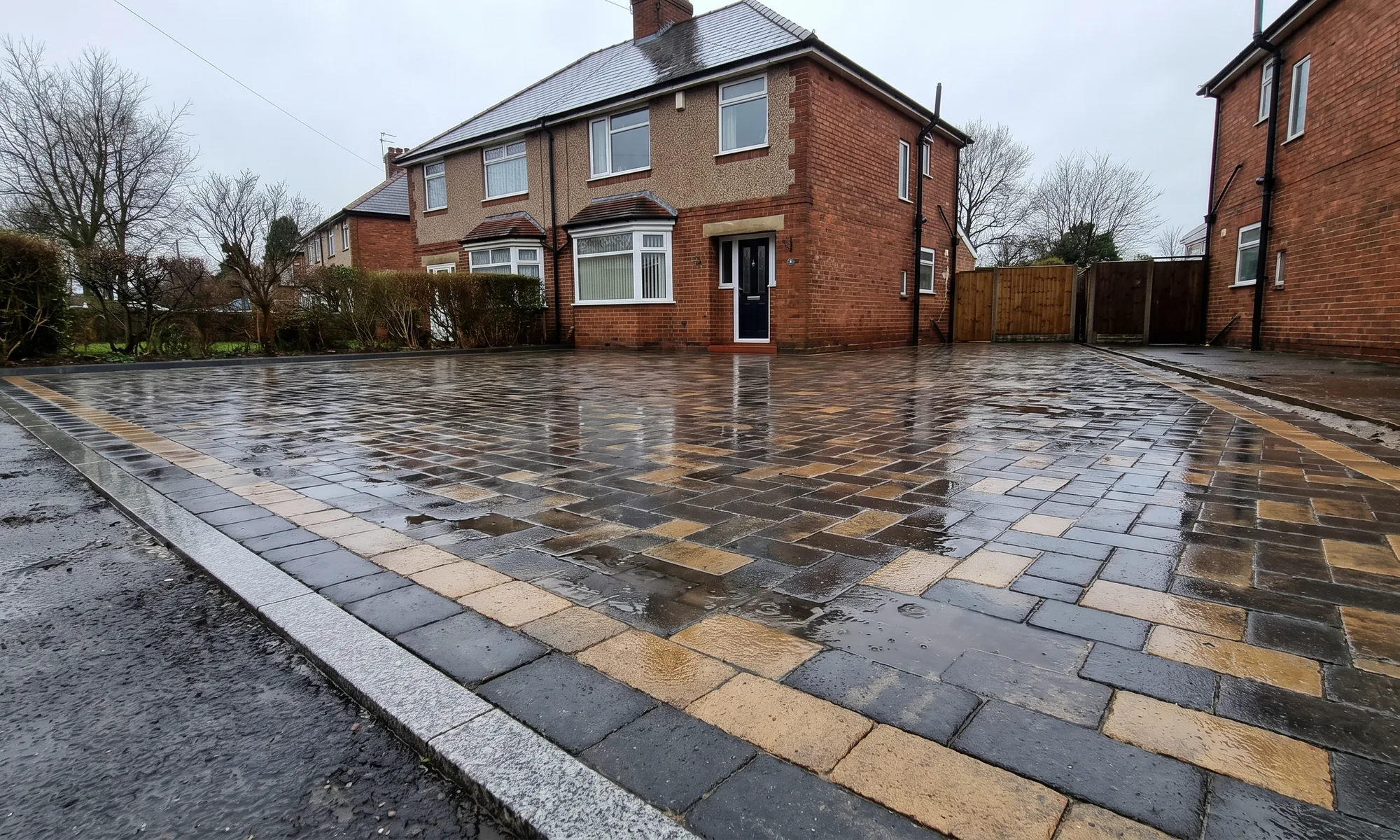 A finished block paved driveway, wet after rain